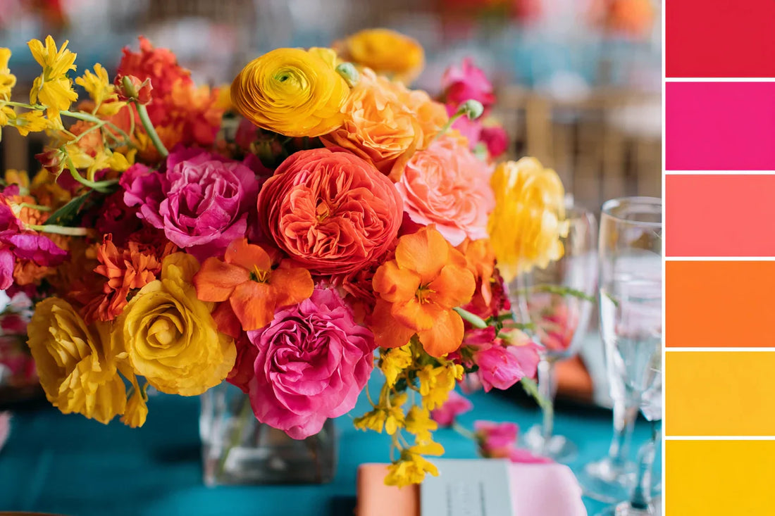 Vibrant summer wedding color palette with bold floral centerpiece in yellow, orange, coral, and pink tones, trending wedding inspiration by LinvitInstant
