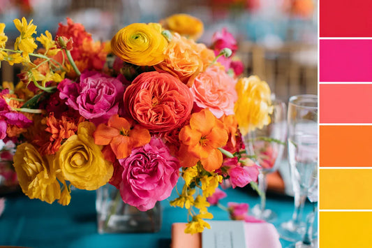 Vibrant summer wedding color palette with bold floral centerpiece in yellow, orange, coral, and pink tones, trending wedding inspiration by LinvitInstant