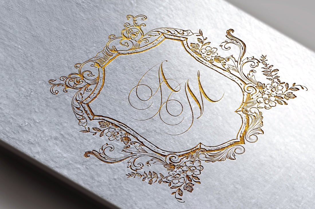 Elegant gold wedding crest with custom initials printed on textured handmade paper