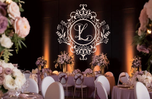 Elegant wedding venue at night with a large wedding monogram projected on the wall using gobo lighting